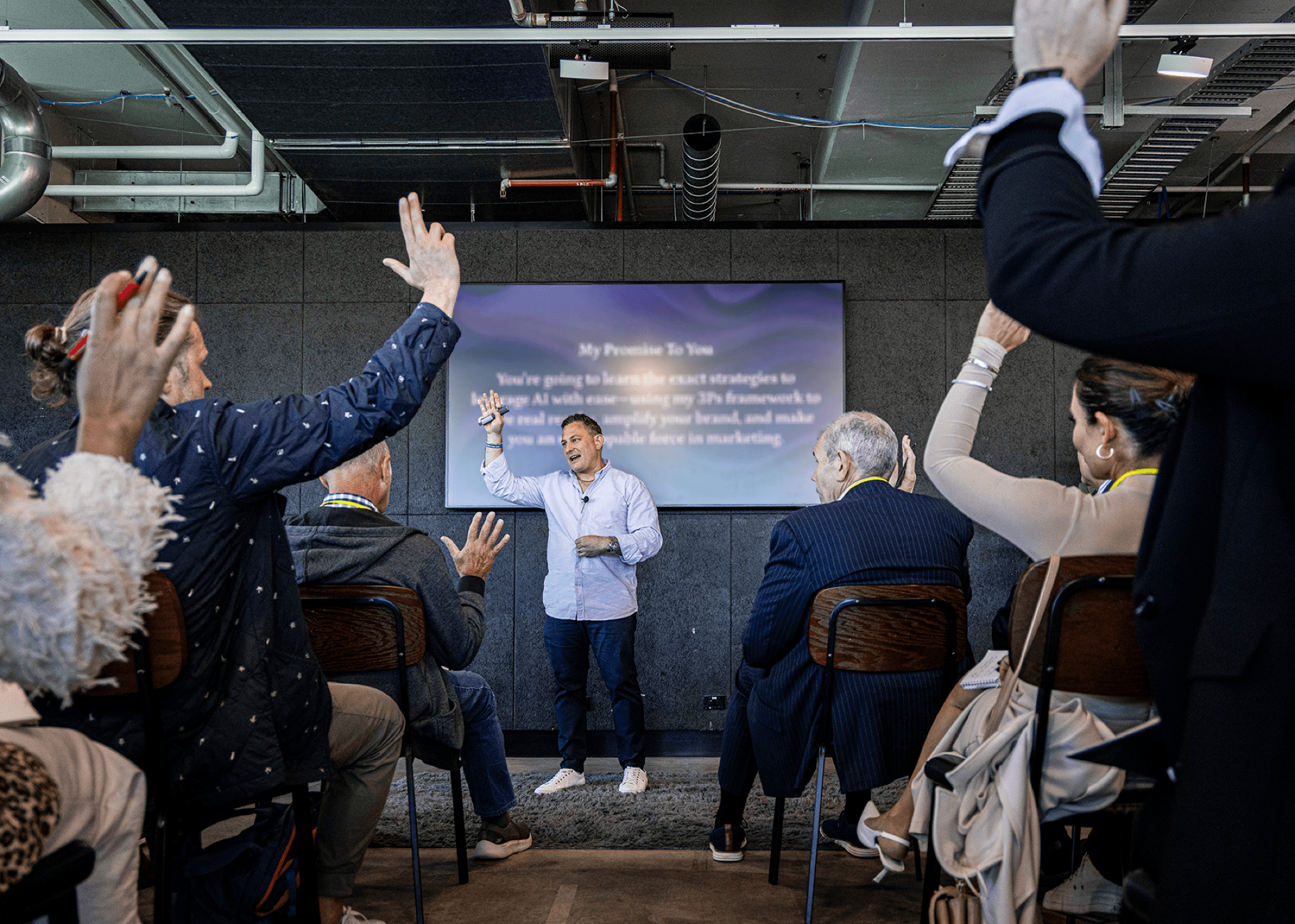 Justin Kabbani leading an interactive AI workshop with audience participation